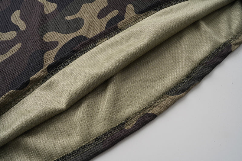 Inside view of camo jersey hem with beige lining and visible seam stitching