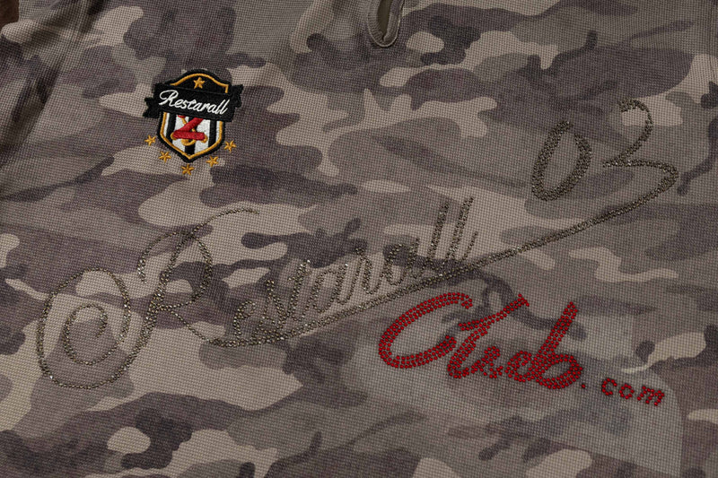 Close-up of gray camo hooded short-sleeve tee with rhinestone script and embroidered crest logo