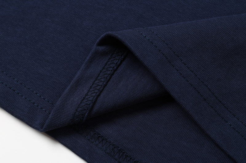 Close-up of navy tee sleeve hem and stitched cuff detail