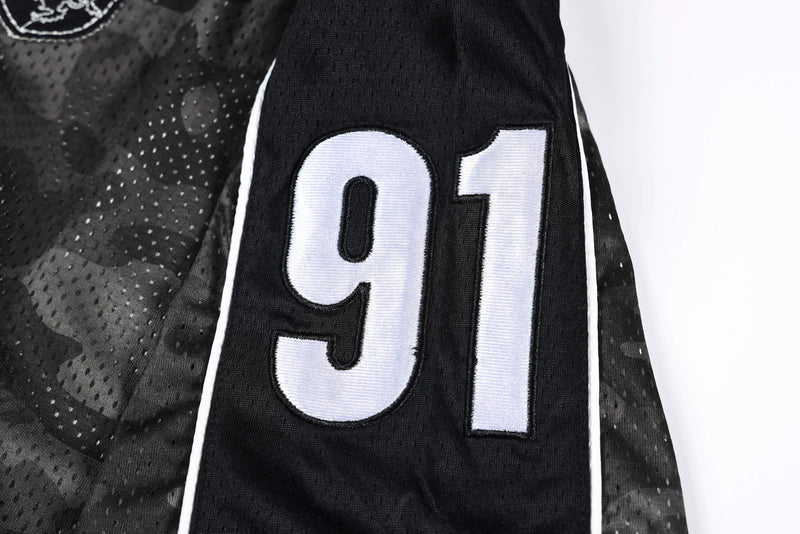 Black camo mesh athletic jersey sleeve with white 91 number patch and football-inspired styling