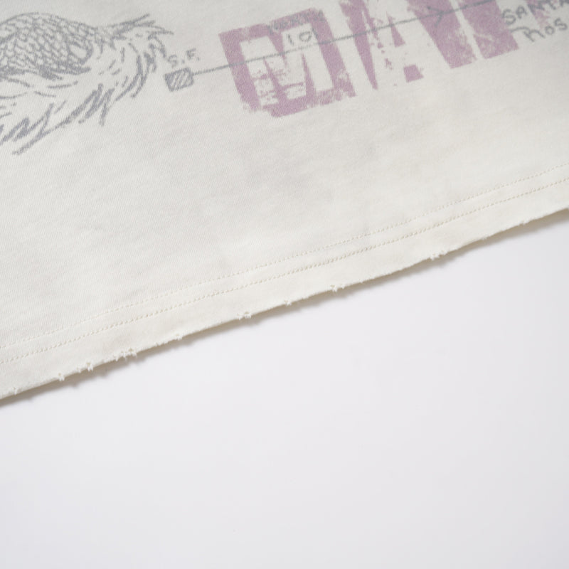 Close-up of lower hem showing faded graphic print and stitched edge