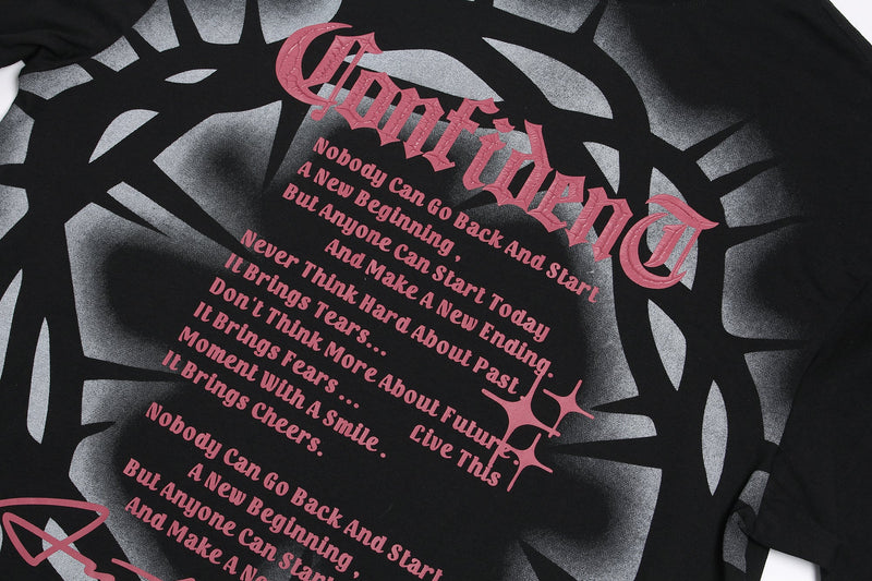 Black gothic T-shirt with pink Crown of Thorns typography and bold inspirational text on a gray abstract background