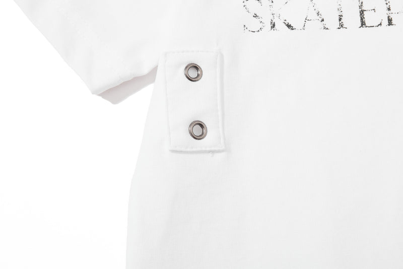 White distressed graphic polo shirt with snap placket and metal eyelet details, shown in close-up on a clean background