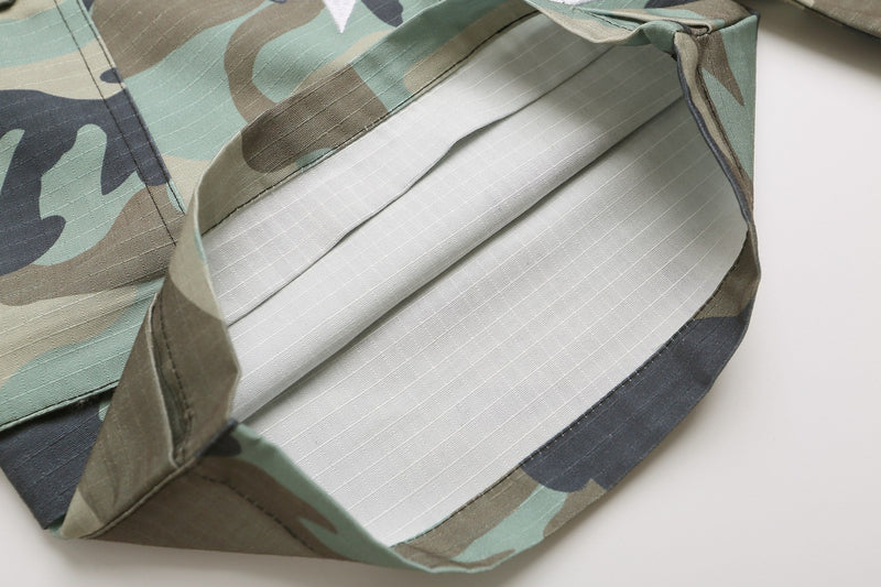 Close-up of open cargo pocket interior with white lining on camo shorts