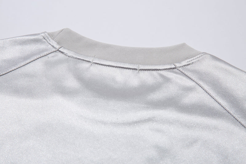 Close-up of white jersey tee back neck seam and ribbed collar