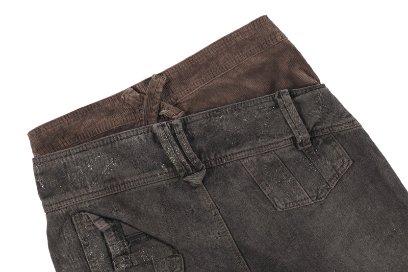 Close-up of back waistband on dark brown jeans with crossed belt loop detail