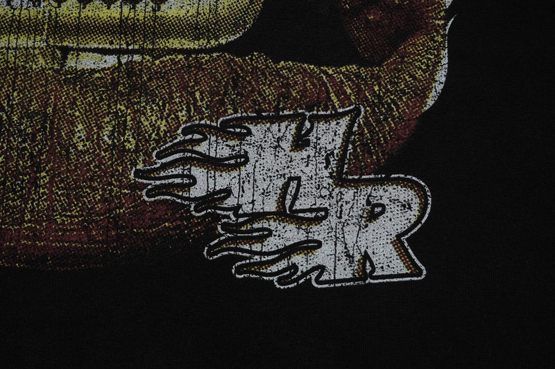 Close-up of a black vintage-washed graphic tee with distressed white Hellrays print and bold streetwear artwork