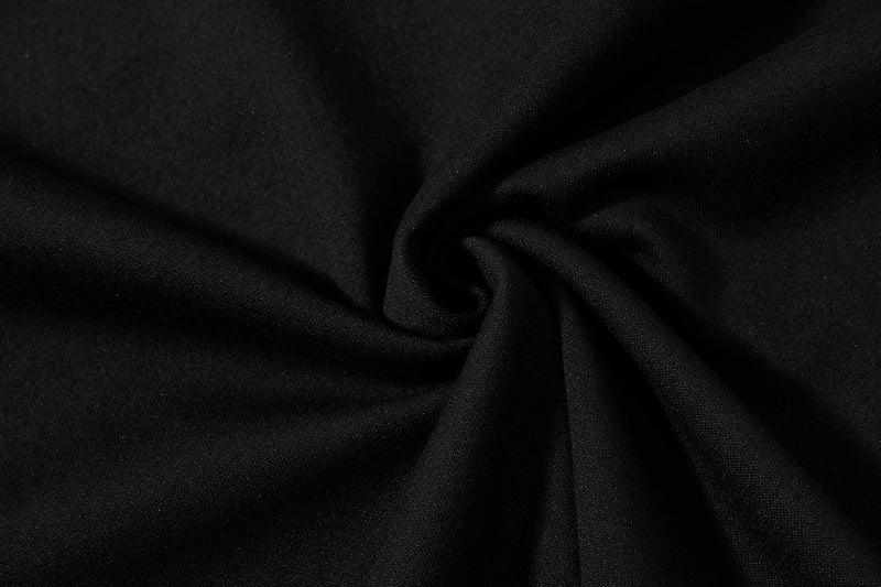 Close-up of black textured polo fabric with soft folds, showcasing the Skatepark Crest streetwear shirt material