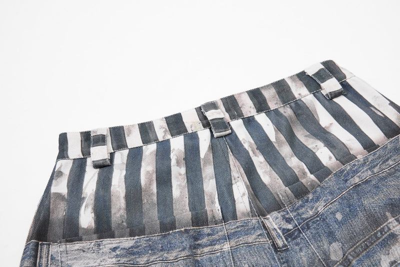 Close-up of striped waistband with belt loops and layered denim seam