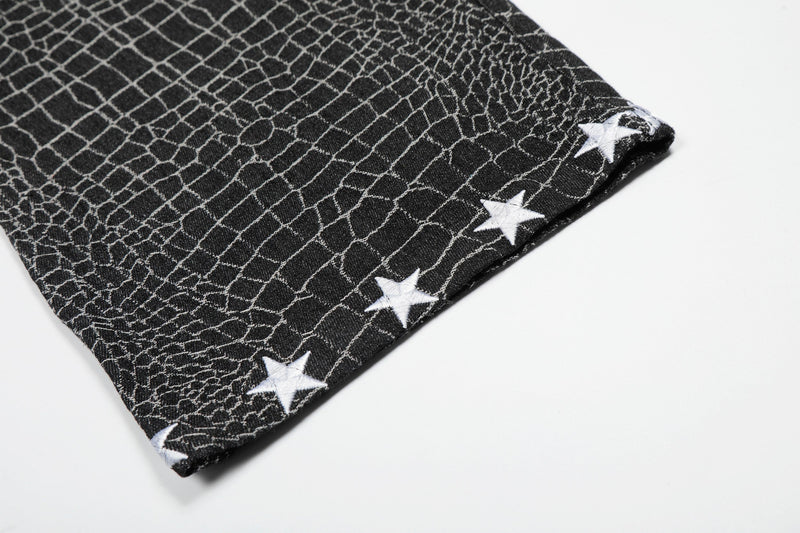 Close-up of black pant hem with white star trim