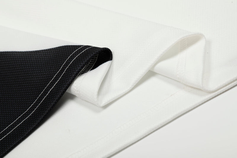 Close-up of sleeve hem with black cuff and white jersey stitching
