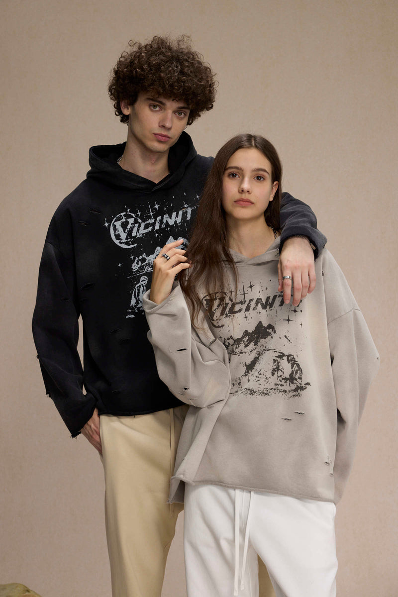 Two models wearing black and gray distressed Vicinity hoodies, close standing pose