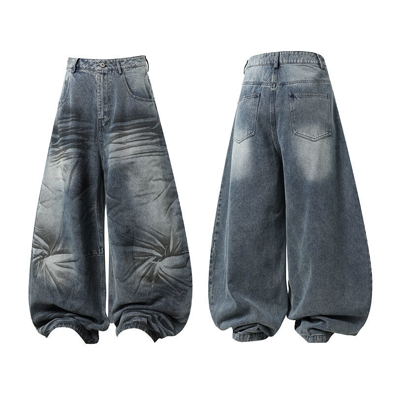 Front and back view of oversized wave-wash barrel jeans in vintage faded indigo denim with starburst distress pattern