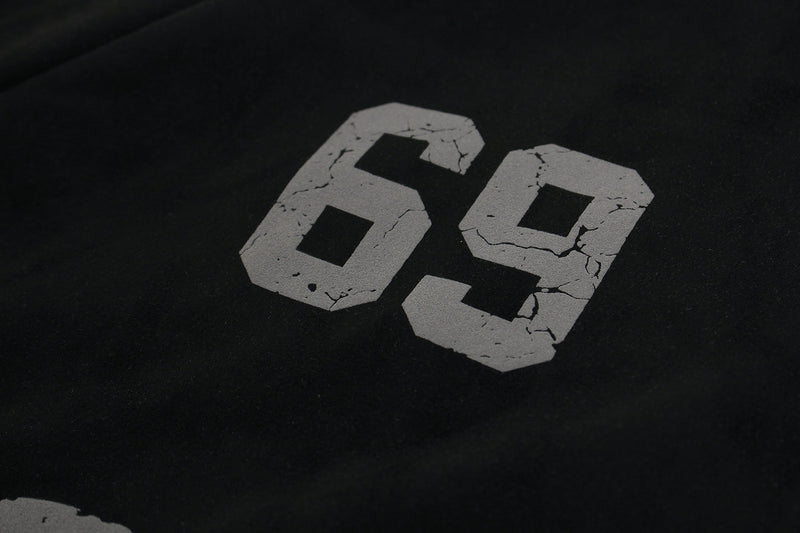 Close-up of 69 graphic printed in cracked gray on black hoodie chest