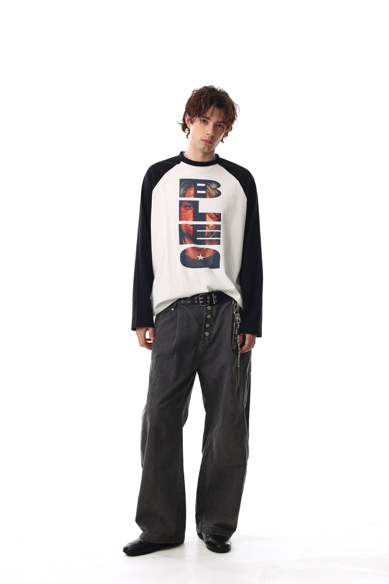 Model wearing black and white raglan long sleeve tee with vertical front graphic and relaxed fit