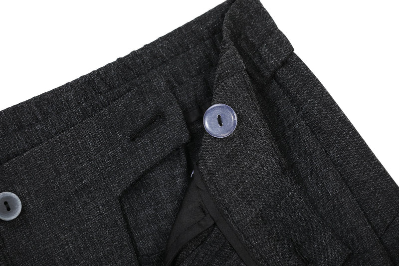 Close-up of black pants waistband with textured fabric and top button detail
