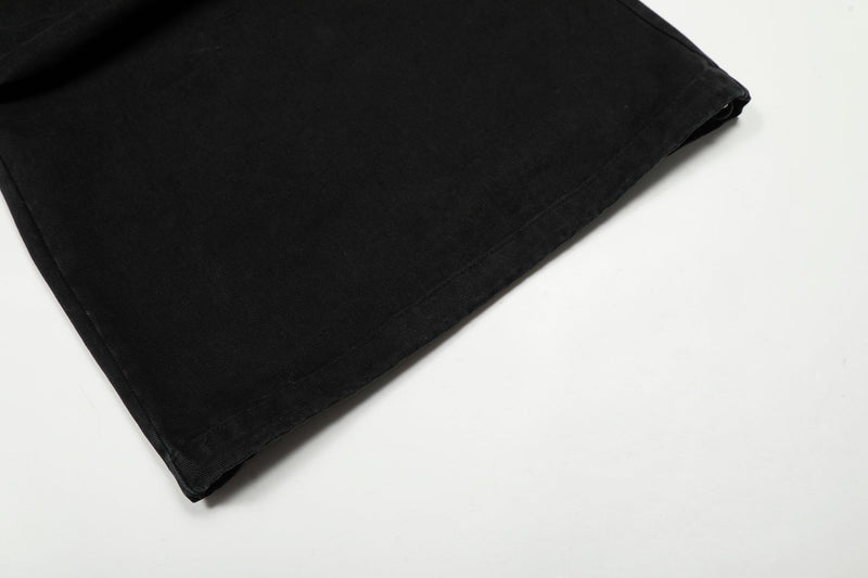 Close-up of black wide-leg pant hem with stitched edge