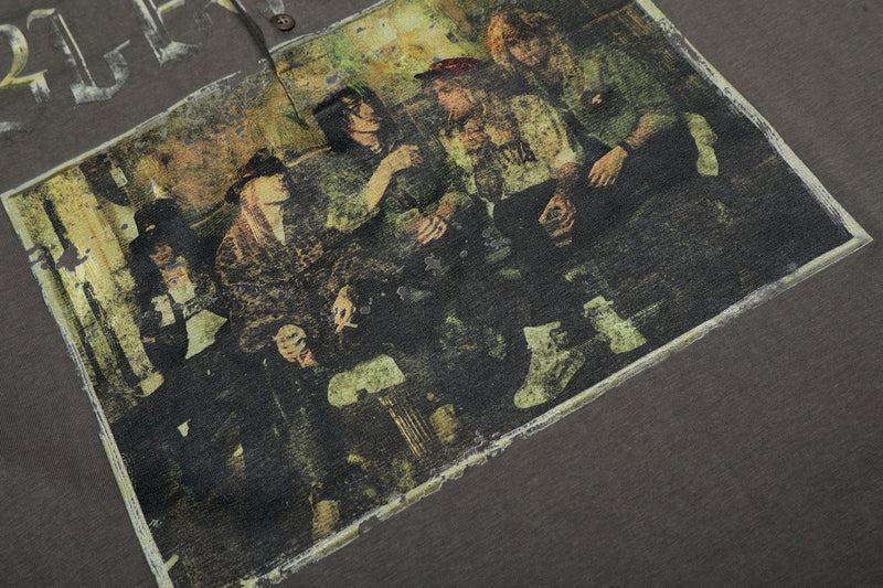 Close-up of distressed band-style graphic print on charcoal layered long sleeve tee