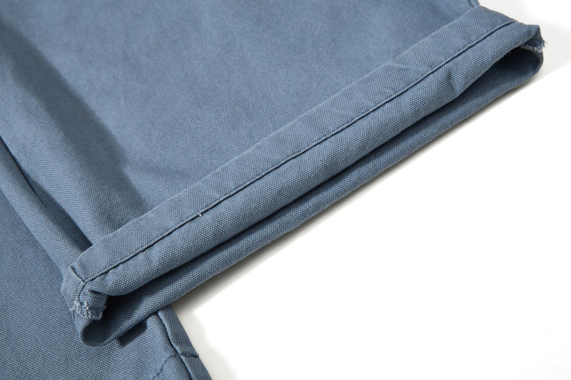 Close-up of blue cargo pant hem with wide cuffed leg