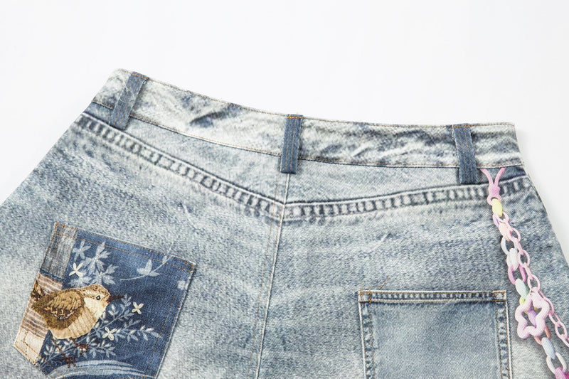 Close-up of back waistband and pocket area on light wash denim shorts with patch detail