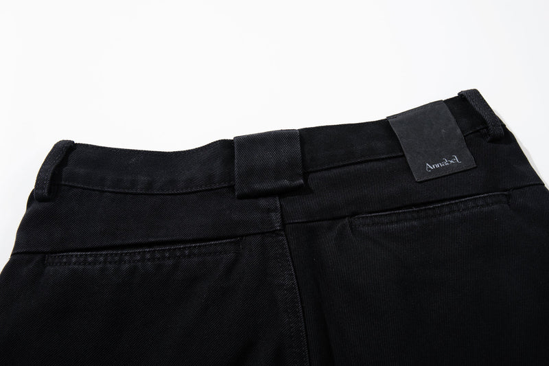 Back waistband close-up of black jeans with loop detail and Annabel label