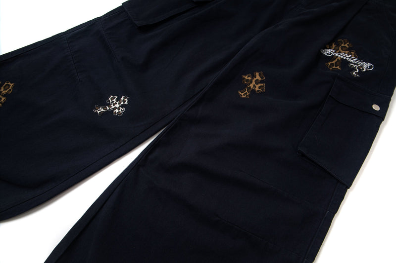 Black cargo pants with leopard cross patches and side cargo pocket, angled view