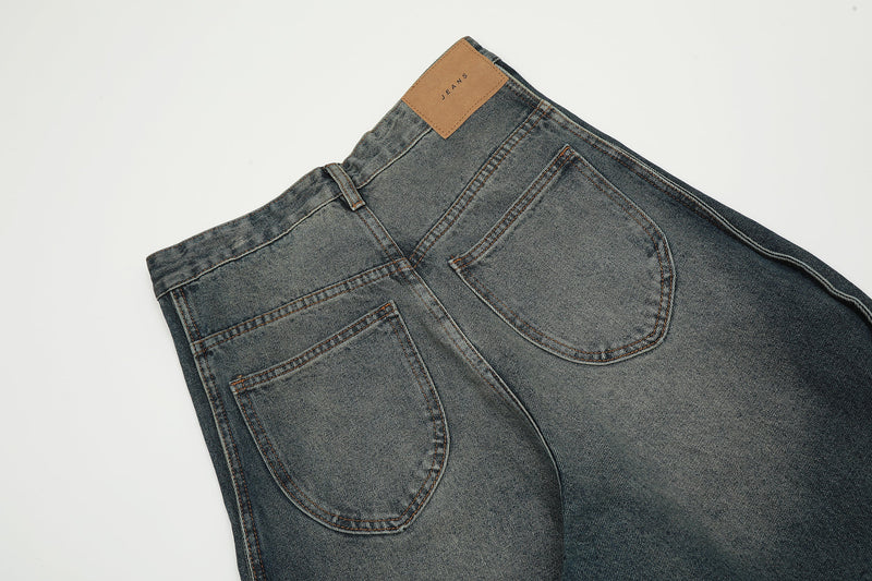 Close-up of back waistband and patch pockets on vintage wash wide-leg jeans