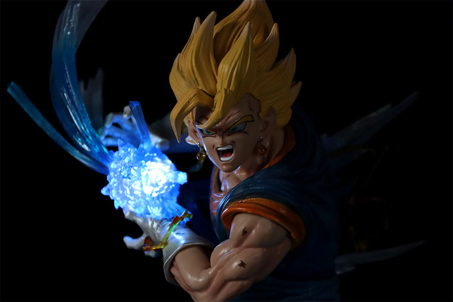 The Seakoff Goku Transformations Collectible Figure, 46cm, showcases an anime character with spiky yellow hair in a dramatic pose, holding a glowing blue energy sphere. It features interchangeable heads and a dark outfit with white gloves against a black background.