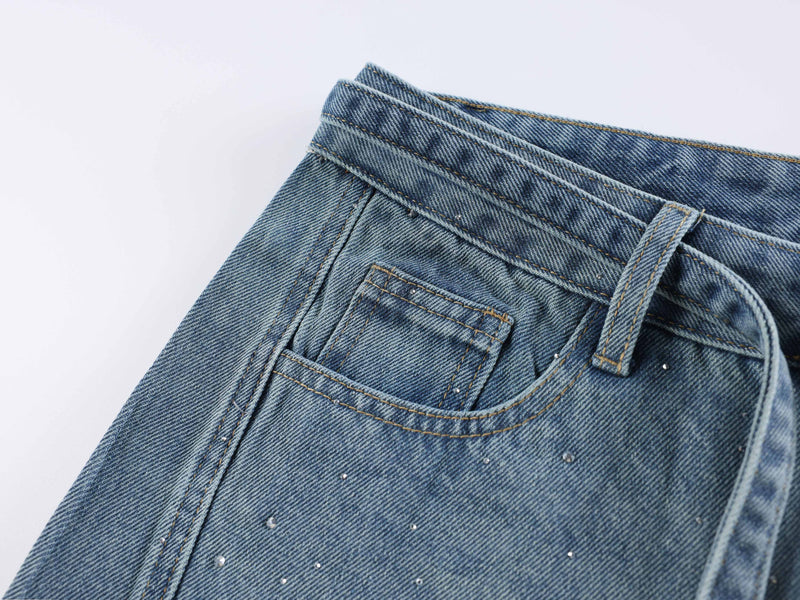 Light blue back pocket close-up with rhinestone-speckled denim