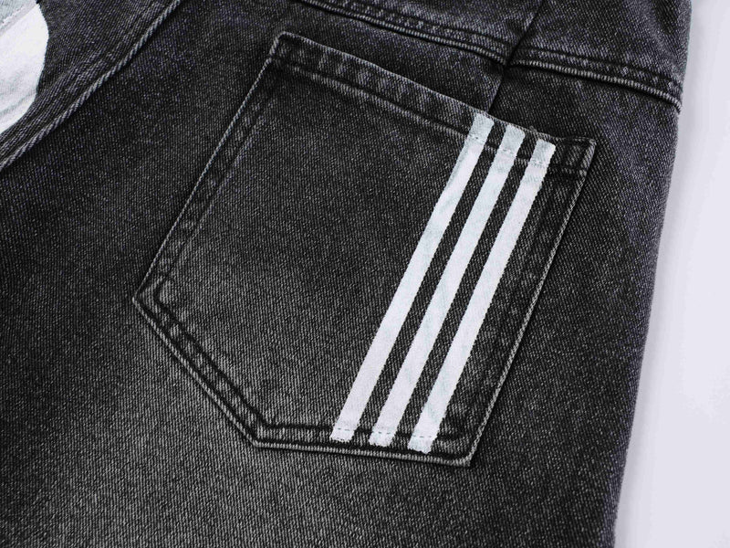 Close-up of black denim back pocket with three white side stripes