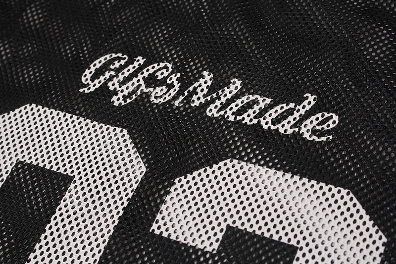 Close-up of black mesh jersey tee with white GlfsMade lettering and large perforated number print