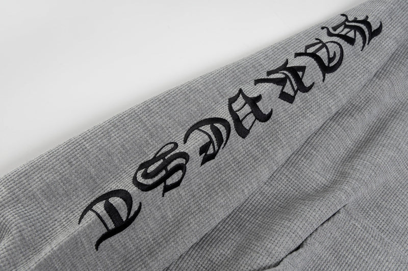 Close-up of gray sleeve with black gothic script print