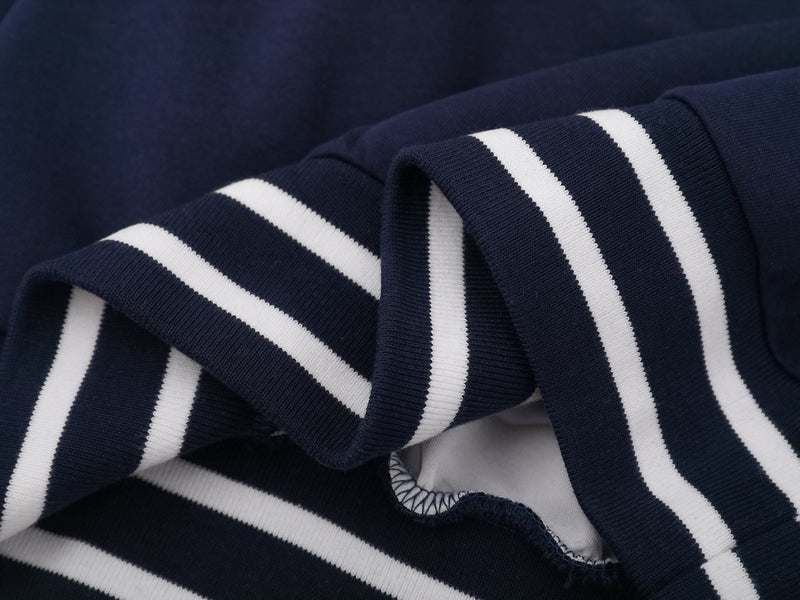Close-up of navy striped sleeve cuffs and ribbed knit detailing