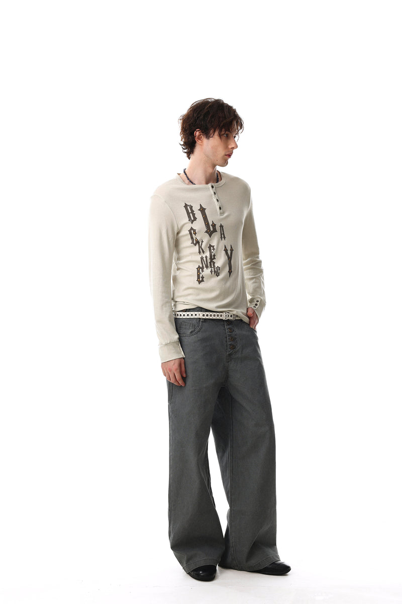 Cream gothic graphic Henley tee worn by model, angled side view