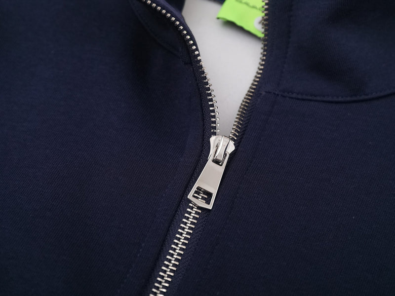 Close-up of silver zipper and collar on navy mockneck sweatshirt