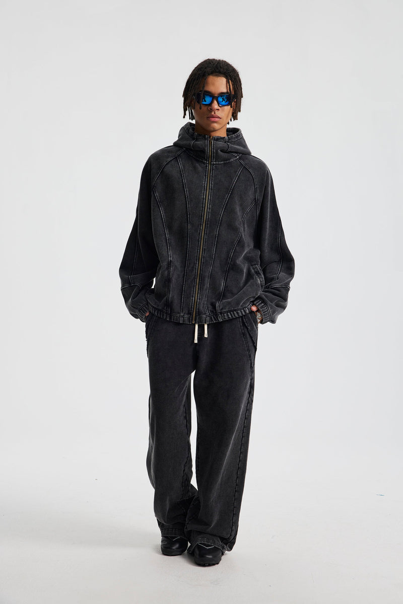 Full-body front view of black full-zip hoodie with hood down on a model