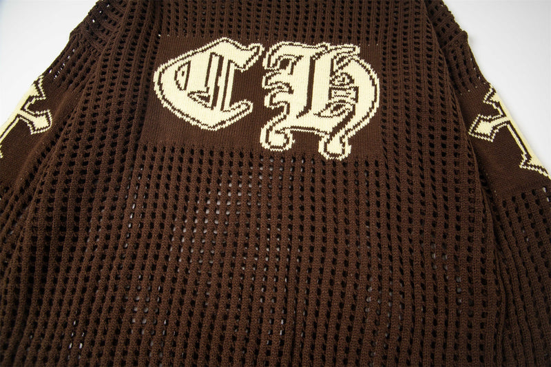 Close-up of brown open-knit sweater chest with cream CH varsity graphic