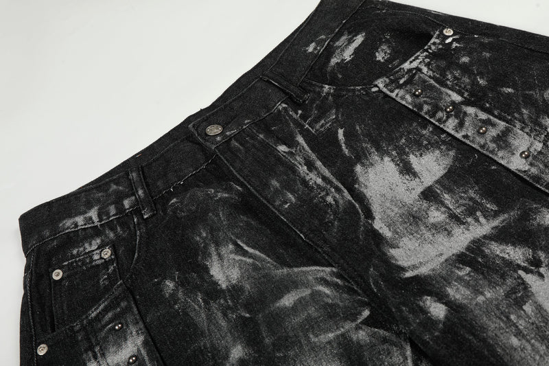 Close-up of black denim waistband and top front with painted wash and studded seam