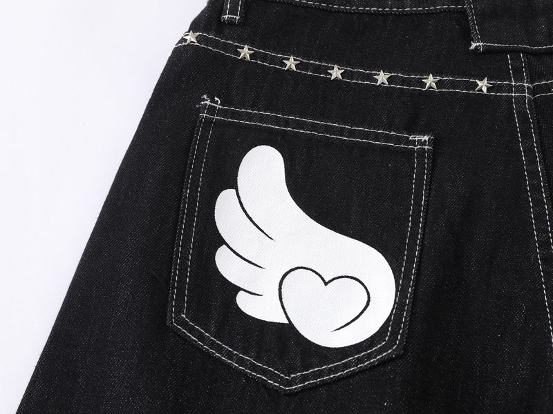 Close-up of back pocket on black jeans with white wing and heart graphic