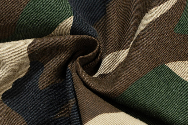 Close-up of camouflage twill fabric with folded crease and diagonal weave texture