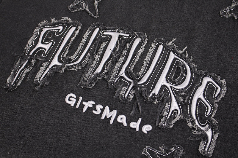 Distressed black graphic T-shirt with frayed white star patch lettering and vintage washed streetwear style