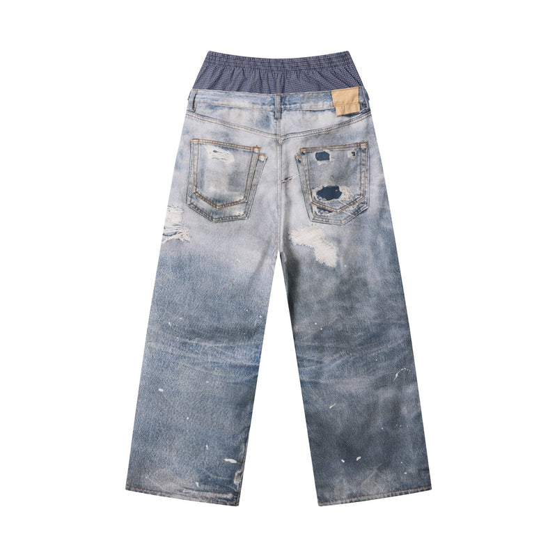 Back view of light wash distressed wide-leg jeans with plaid layered waistband and patch pockets