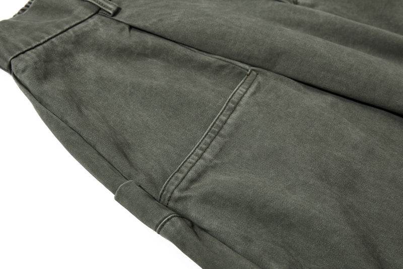 Close-up of olive green front pocket and seam detail