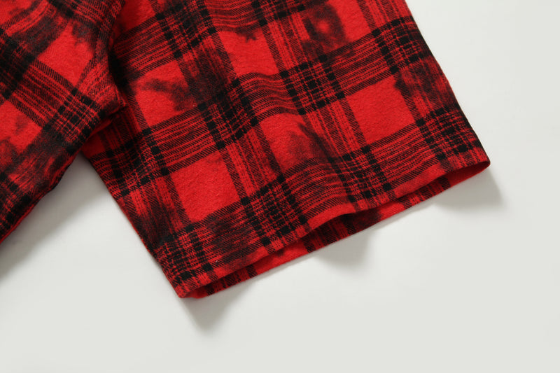Cuffed short sleeve of red and black plaid cropped shirt on white background