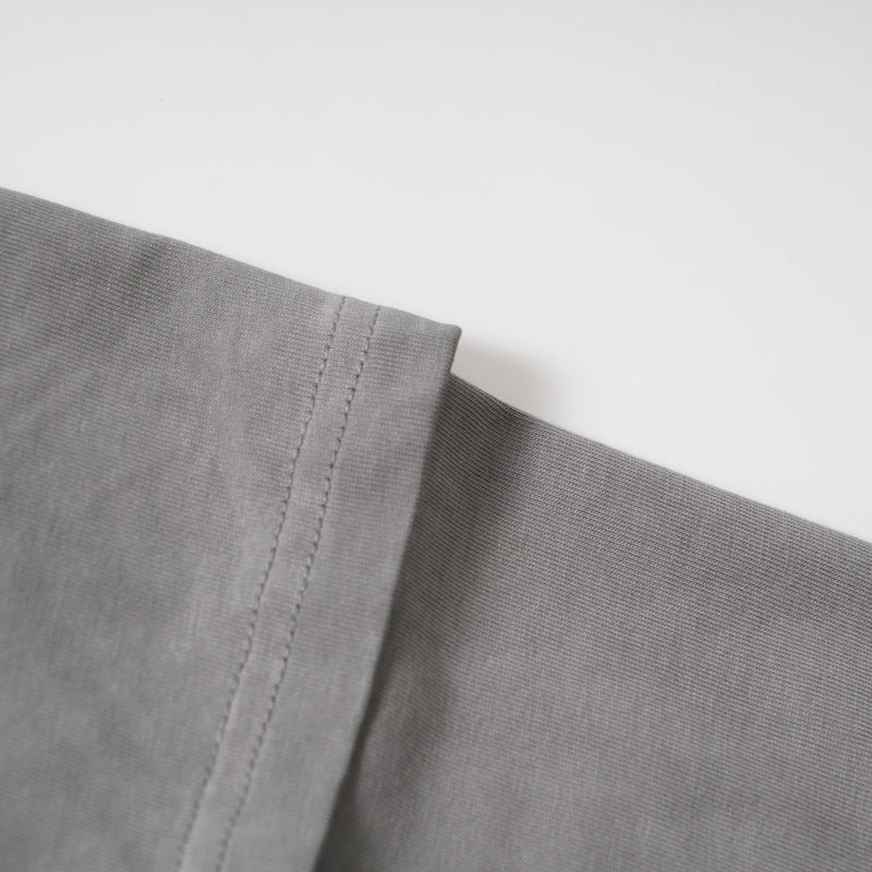 Close-up of the layered sleeve cuff on a washed grey long sleeve tee