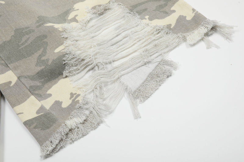 Close-up of frayed tear at the hem of gray camouflage wide-leg shorts