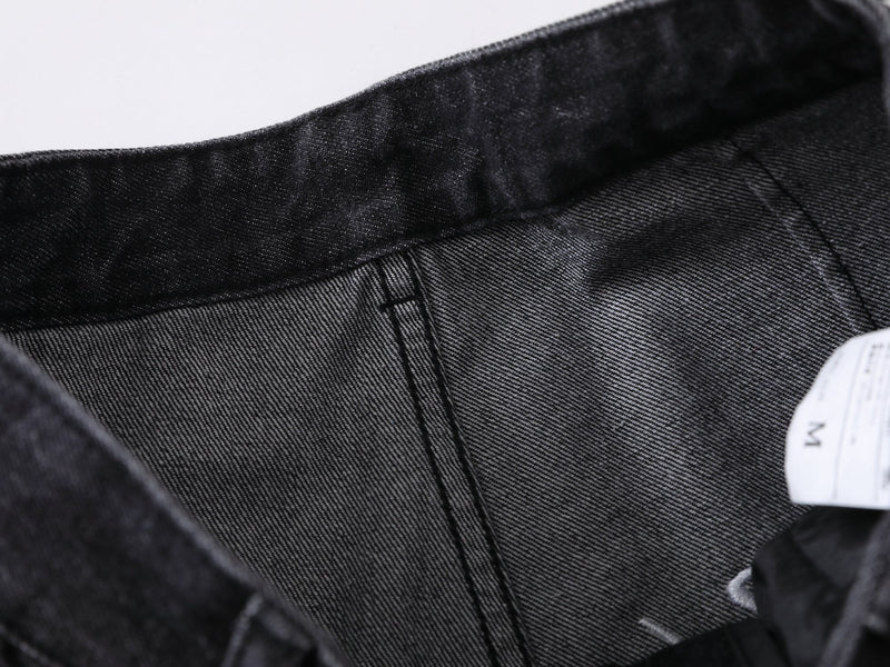 Close-up of black jeans inner waistband lining and size tag
