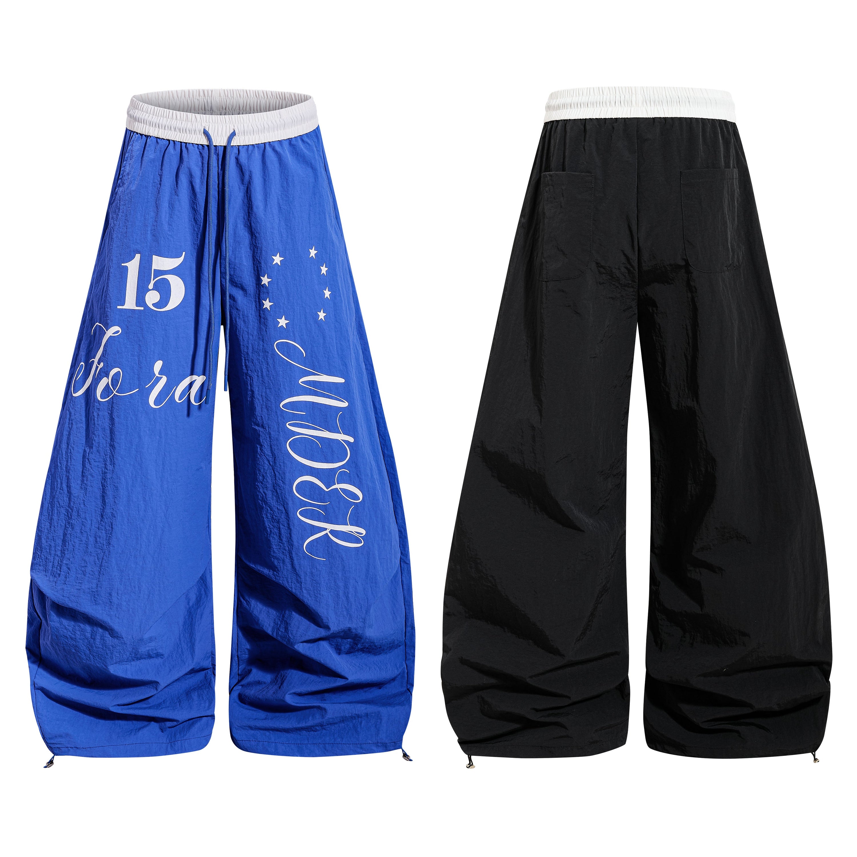 Royal blue wide-leg track pants with white retro script lettering, number 15, and star graphics, shown front and back