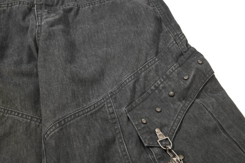 Dark gray cargo pants pocket detail with snap flap and side buckle strap