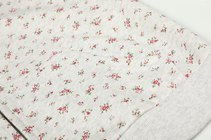 Close-up of floral hoodie back panel and ribbed hem seam